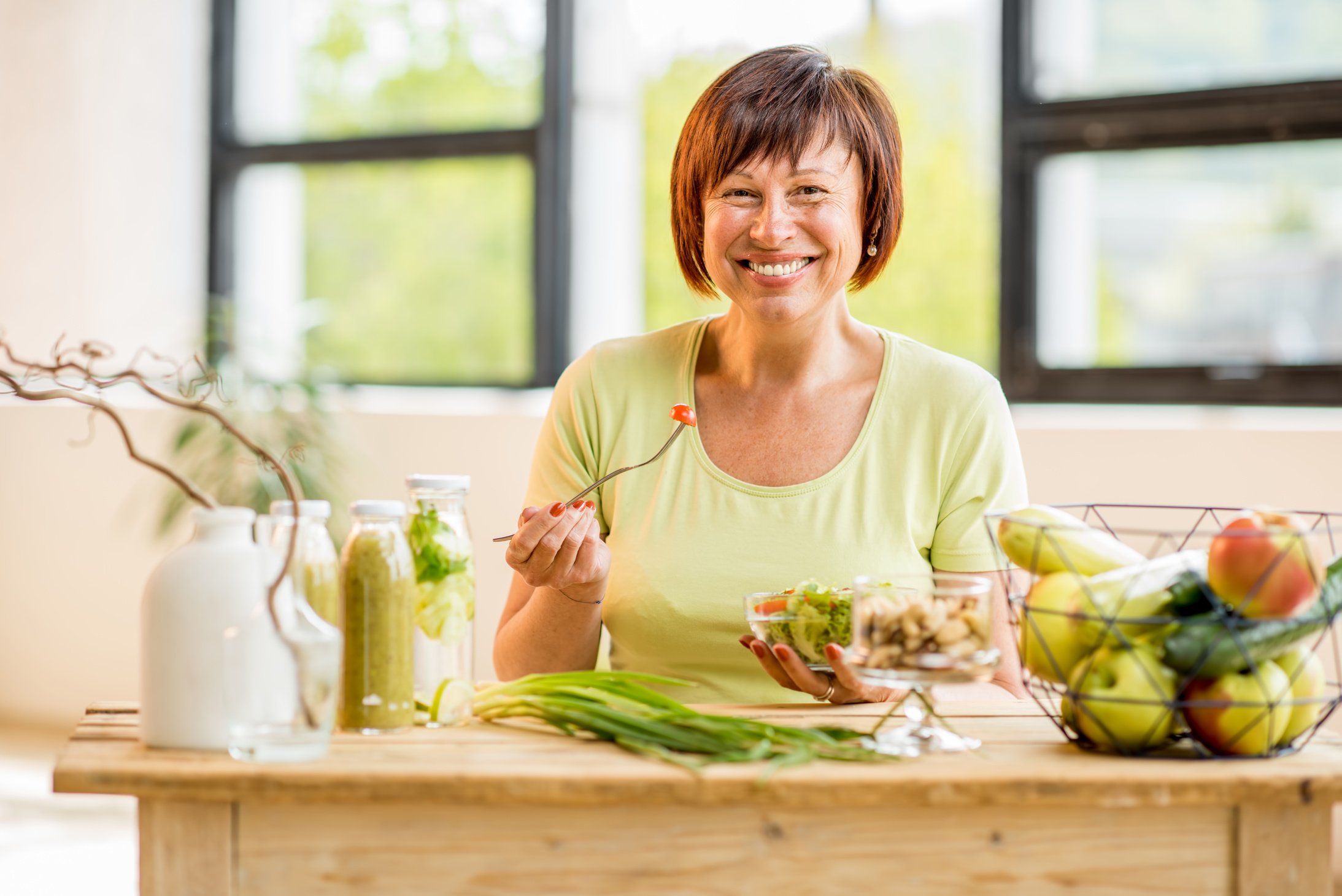 Older woman with healthy food indoors