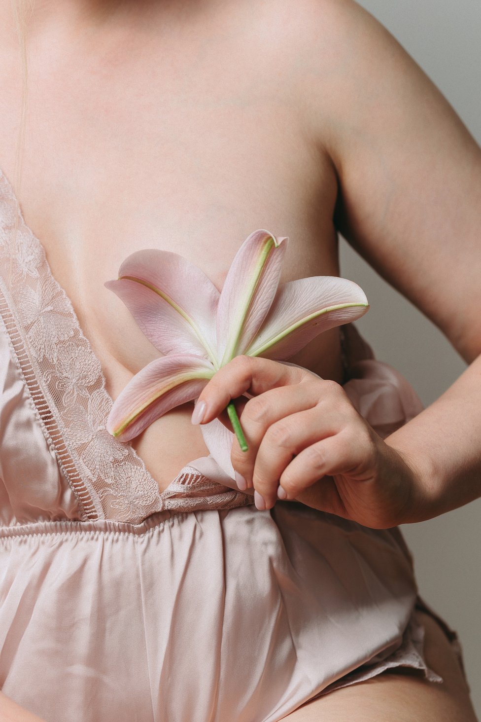 Calla Lily Covering Woman's Breast